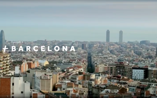 A panoramic view of Barcelona’s cityscape with densely packed buildings, two world class towers in the distance, and the word BARCELONA written across the image.