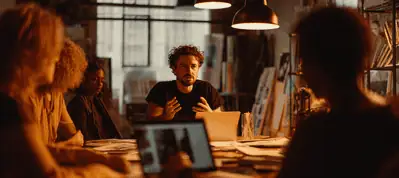 Four people sit around a table in a dimly lit room, engaged in discussion. Warm lighting and shelves create a cozy atmosphere—perfect for filming in Birmingham, with papers and a laptop scattered on the table as one person gestures while speaking.