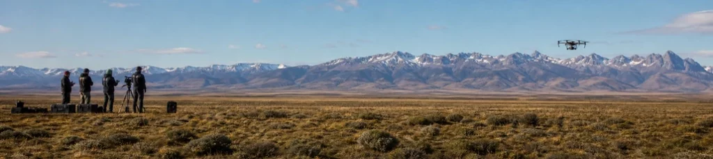 A film crew with a drone shooting in the Patagonian steppe