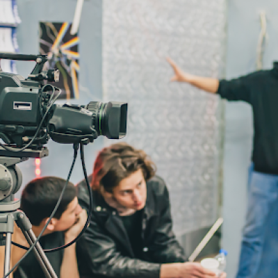 A group of people sitting at a table, sharing production tips to ensure a smooth production.