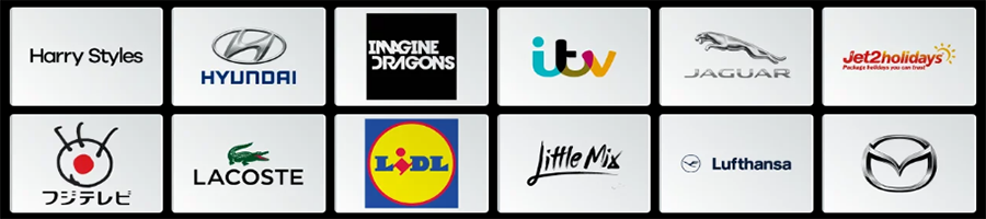 A grid of twelve logos, including Harry Styles, Hyundai, Imagine Dragons, ITV, Jaguar, Jet2holidays, a Japanese logo, Lacoste, Lidl, Little Mix, Lufthansa, and Mazda.